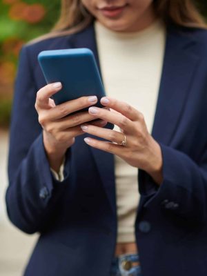 Smartphone in manicured hands of female entrepreneur